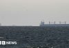 Strait of Hormuz closed again, Iran says, as ships attacked – BBC