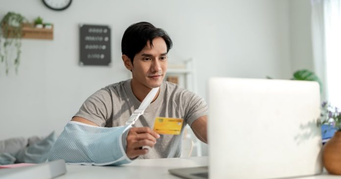 by-s_kawee-from-envato_injured-asian-man-with-hand-splint-using-laptop-fo-2026-01-11-11-12-51-utc_in.jpeg